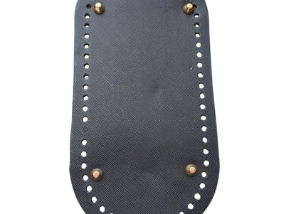 Black sandal sole with gold studs on a light gray background
