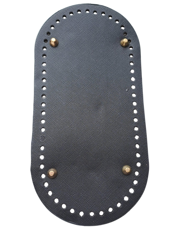 Black sandal sole with gold studs on a light gray background