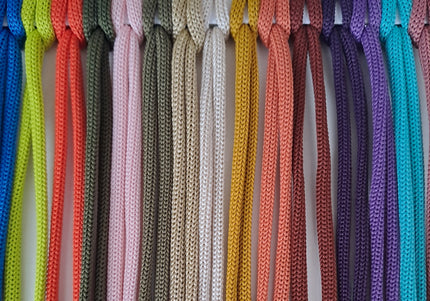 Polyester cord color sample for macramé and crochet, showing cords in shades of red, pink, burgundy, glitter green, bright green, olive, teal, dark green, beige, ivory, tan, blue, and yellow, labeled from 25 to 38.