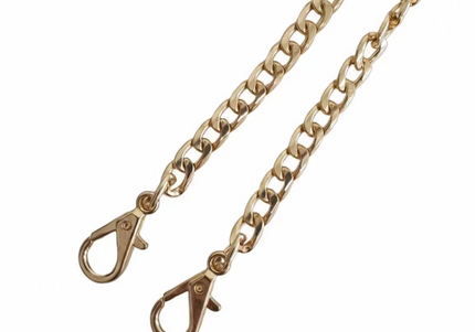 Gold chain with clasp on a light gray background
