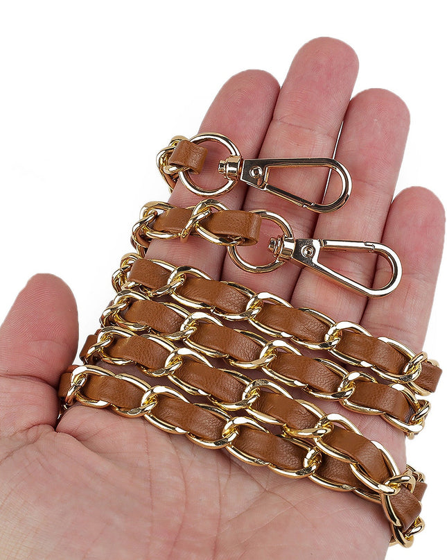 Brown leather chain with gold metal clasp held in a hand on a white background