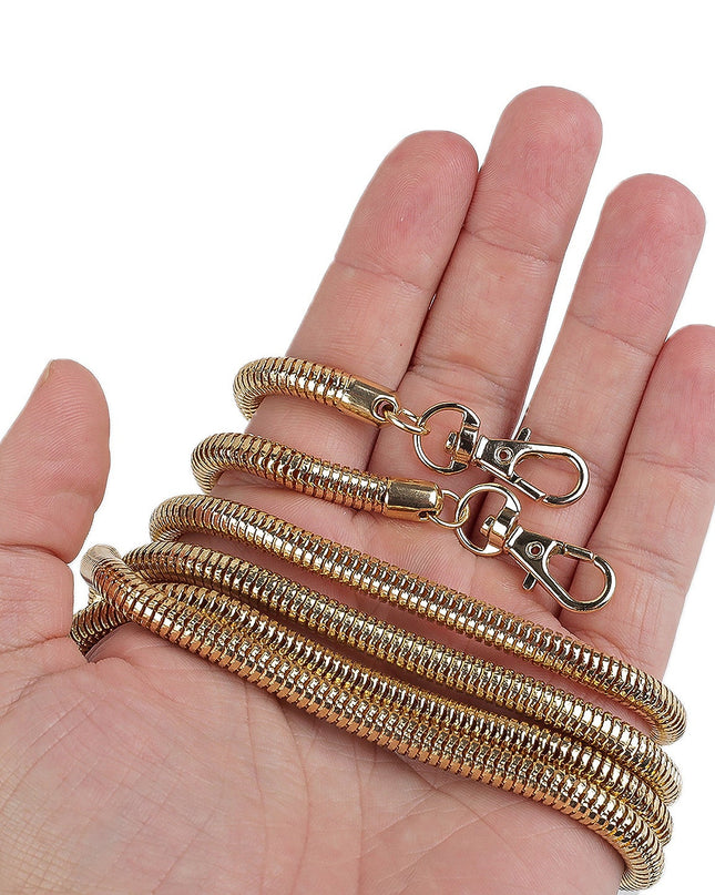 Gold chain with clasp held in a hand against a white background