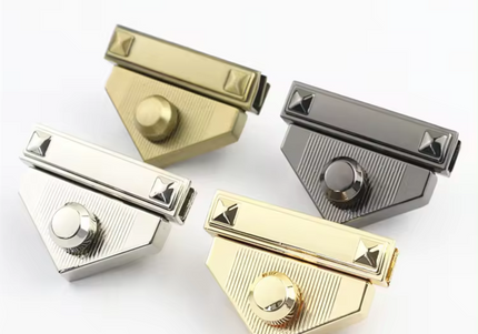 Four triangle-shaped metal turn lock clasps for crochet or knitted bags in gold, silver, antique brass, and gunmetal colors.