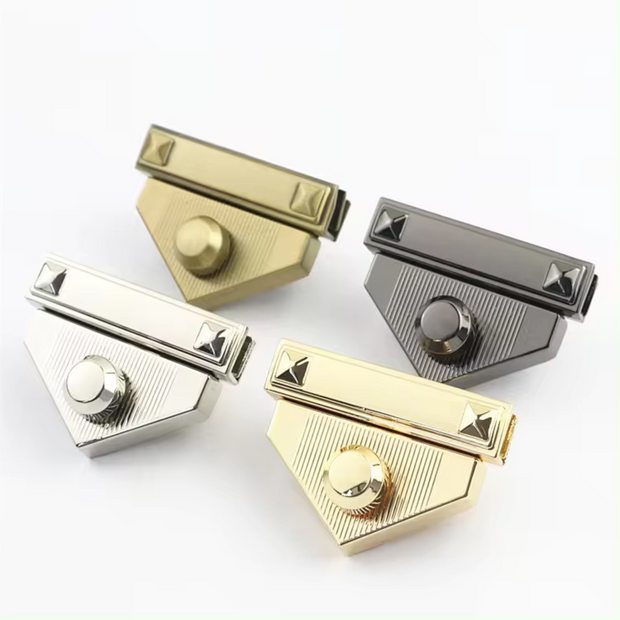 Four triangle-shaped metal turn lock clasps for crochet or knitted bags in gold, silver, antique brass, and gunmetal colors.