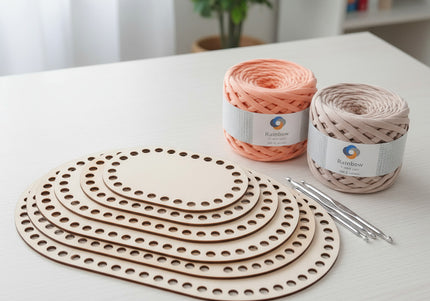 Yarn and crochet hooks on a white surface with a plant in the background