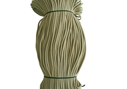 Coiled green rope on a white background